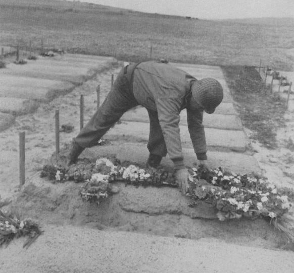 General Eddy placing flowers on a grave 