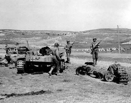 US Infantry men and a destroyed German Armored Fighting Vehicle