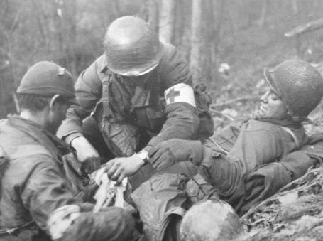 Medics attend to a wounded American Infantry man Medics attend to a wounded American Infantry man
