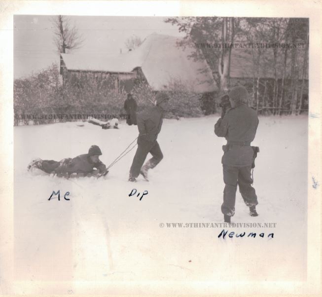 Sgt. Michael Puzak riding a sledge, while Sgt. Newman shoots some film footage.