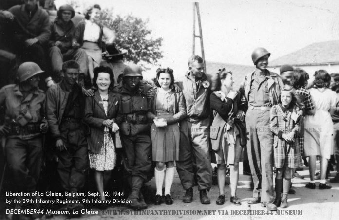 Happy locals pose with GIs of the 39th Infantry Regiment in La Gleize, Belgium, September 12th, 1944.