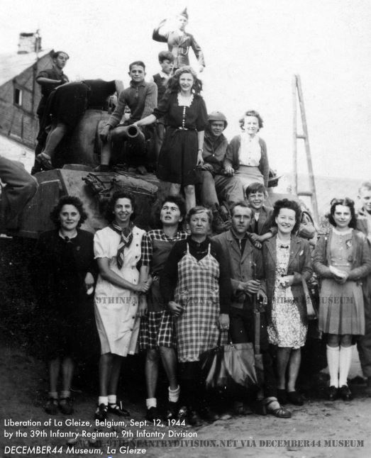 Happy locals pose with GIs of the 39th Infantry Regiment in La Gleize, Belgium, September 12th, 1944.