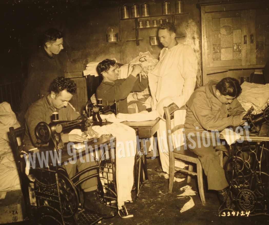 Men of 3rd Battalion, 60th Infantry Regiment receive new snow suits for winter warfare camouflage in January 1945 near Mutzenich, Germany.