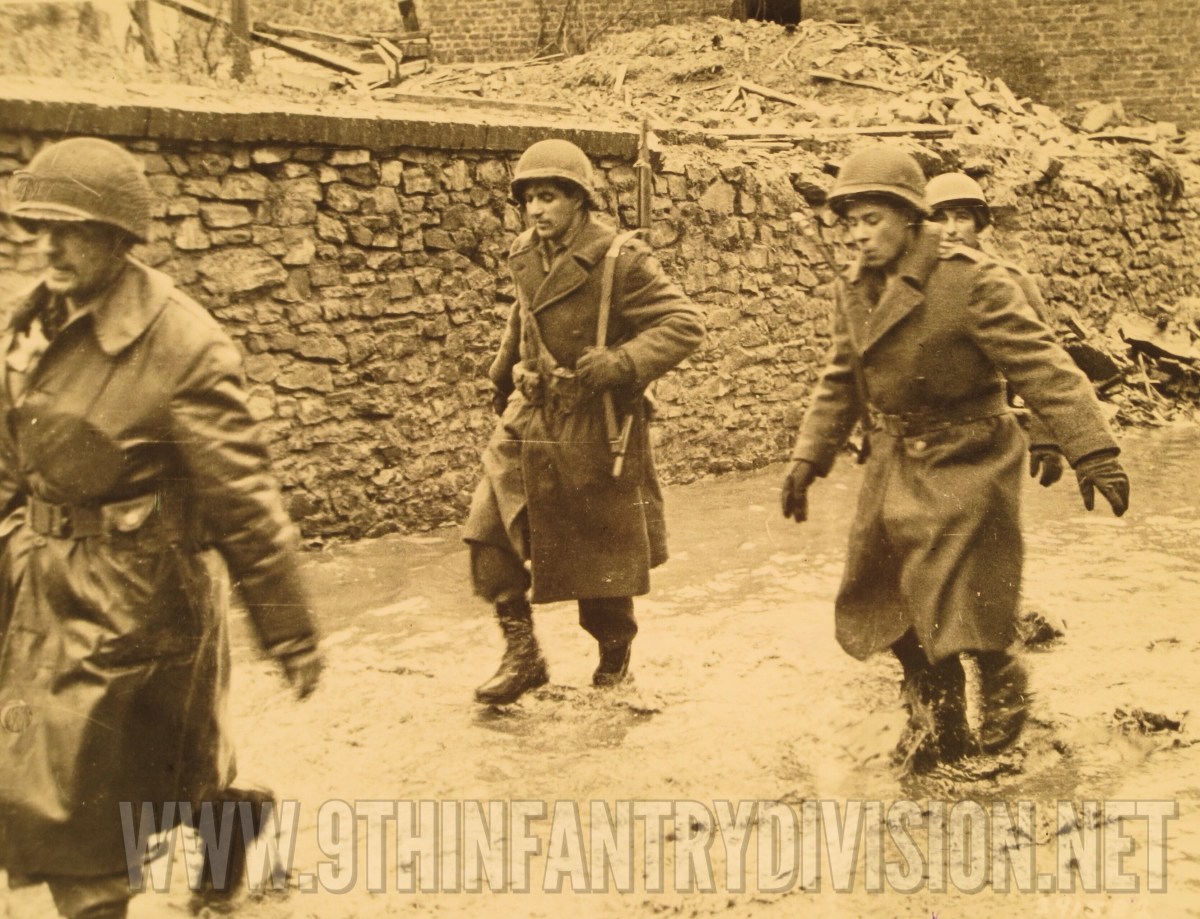 The American soldiers of 2nd Battalion, 39th Infantry Regiment guarding the German prisoners.
