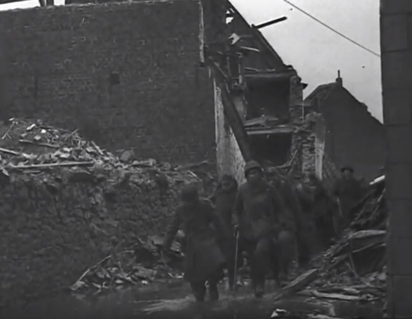 German prisoners walk on the Kapellenstrasse.