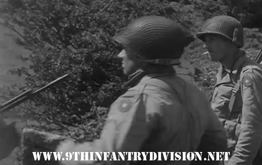 9th Infantry Division men moving through Gréville Hague near Cherbourg, France on 30 June 1944.